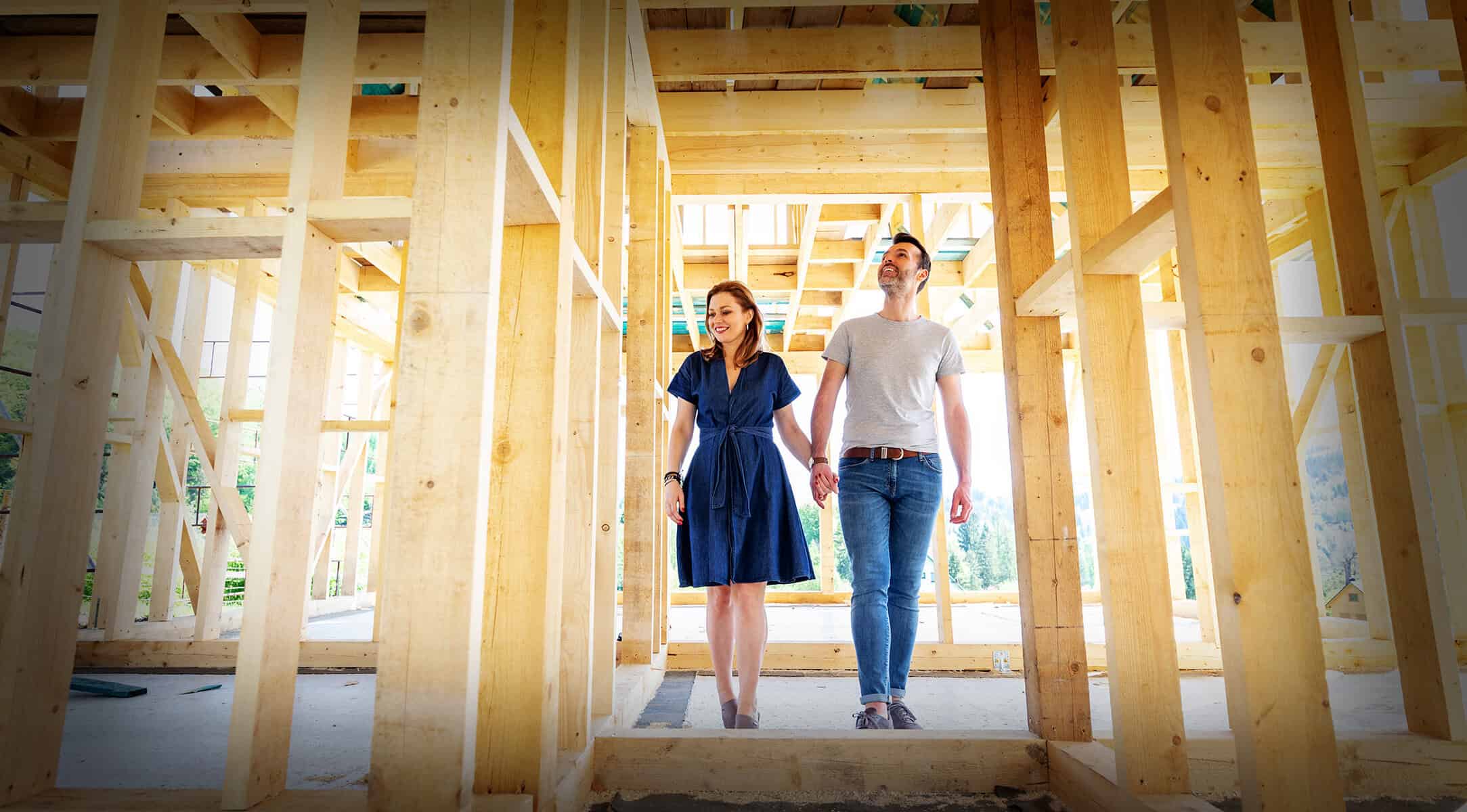 ESPY Building Professionals. Couple looking at the framing construction of their custom home.